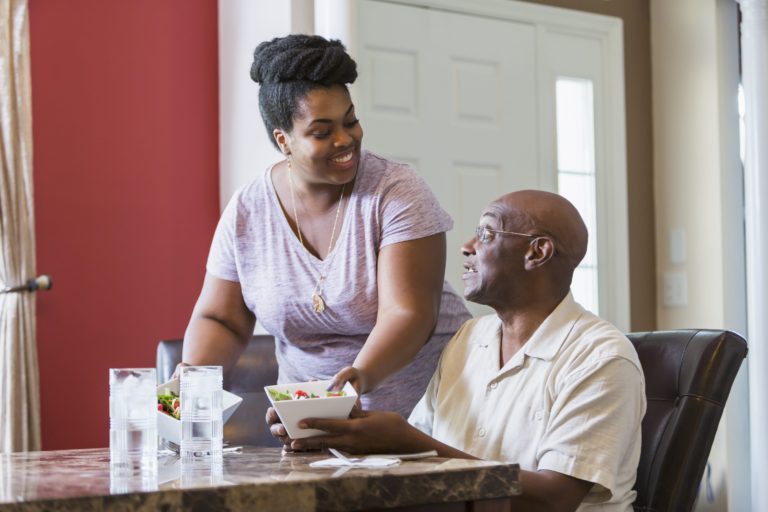 woman helping senior man